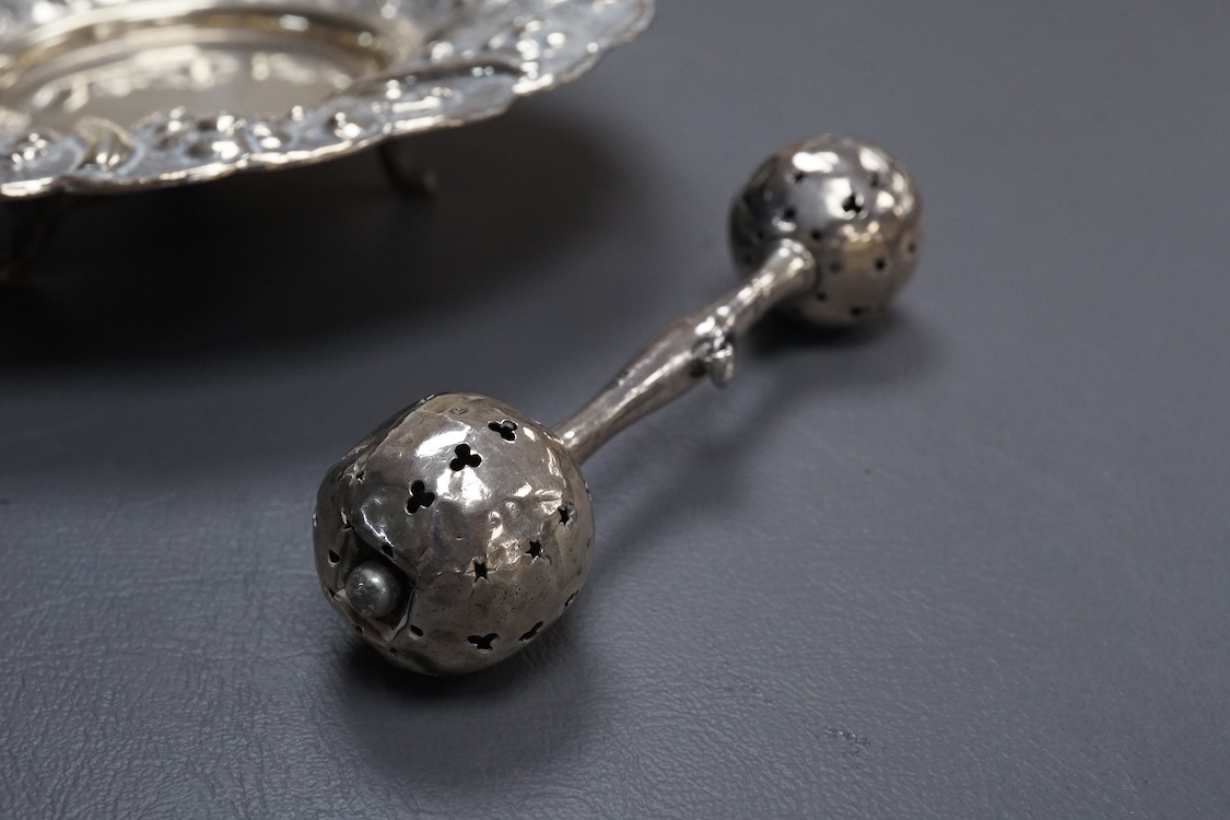 An Edwardian silver child's rattles, of dumbbell form, Crisford & Norris, Birmingham, 1906, 11cm, together with a 20th century Egyptian 900 standard white metal dish, post 1946 mark,(lead solder).